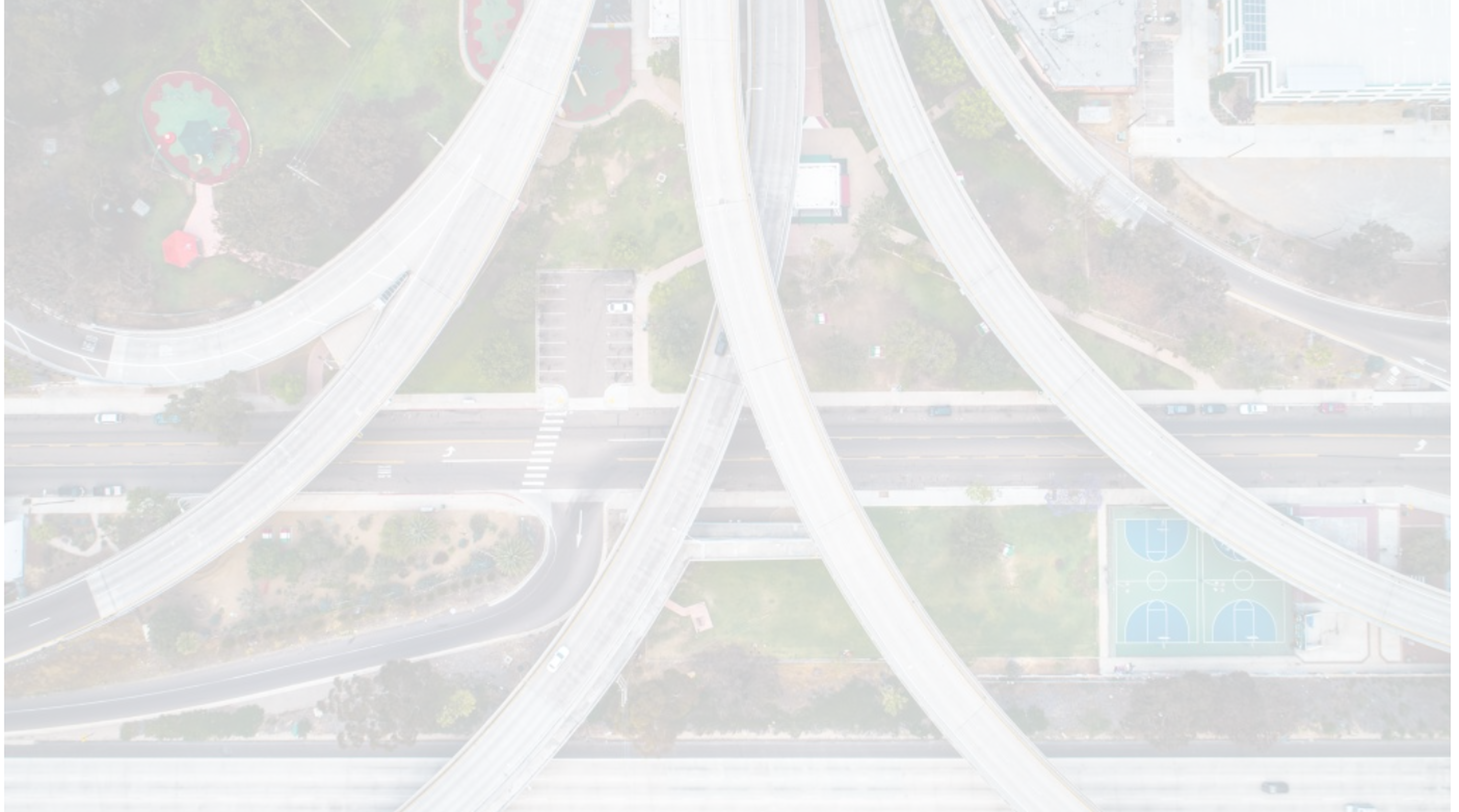 Aerial view of freeway interchange cutting through a neighborhood.